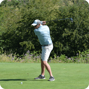 Man hitting a golf ball.