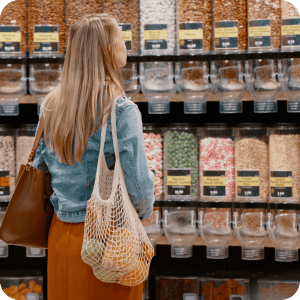 Woman shopping in a bulk grocery store.