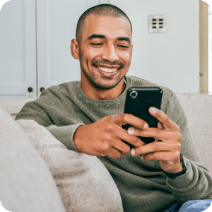 Man looking at his phone and smiling.