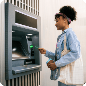 Woman using a card at an ATM.