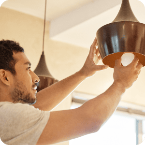 Man putting a new light bulb in.