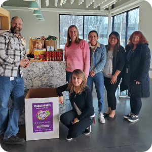 Rivermark volunteers around a donation bin.