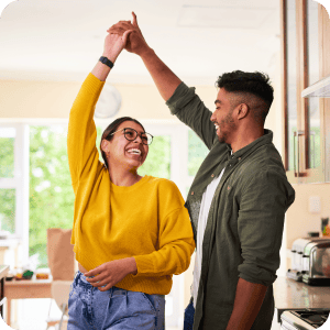 Young couple dancing in the front room.