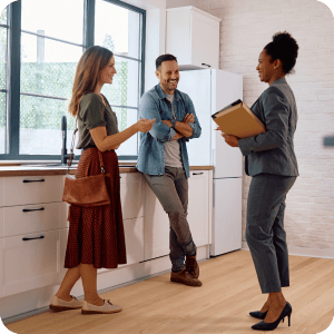 Young couple talking to a realtor.