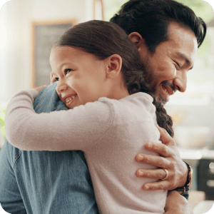 Father hugging his daughter.