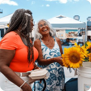 Older women shopping at the farmers market.