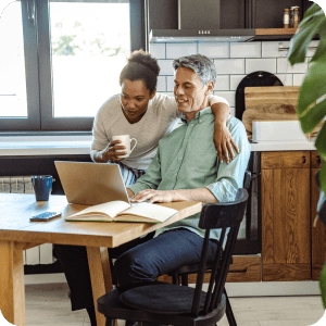 Couple looking at a laptop together.