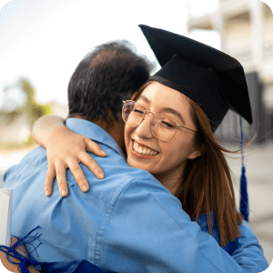 College graduate hugging her dad.