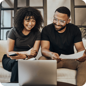 Couple looking at a laptop together.