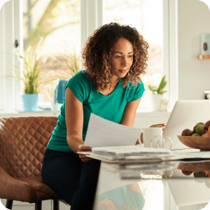 Woman looking at documents at a desk.