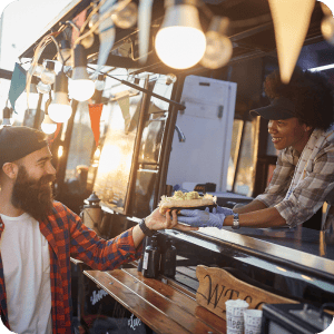 Woman serving food from a food cart.