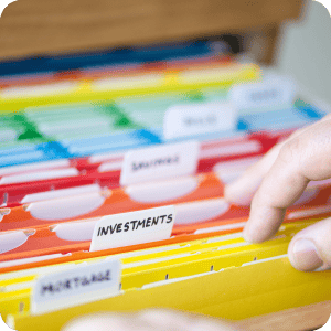 Colorful folders with a hand looking through them.