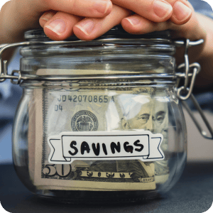 Hands on top of a savings jar.