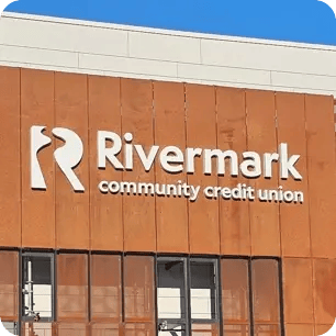 The exterior of the Rivermark headquarters showing the logo signage.