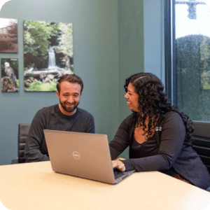 Rivermark employee sitting down with a member for a coaching session.