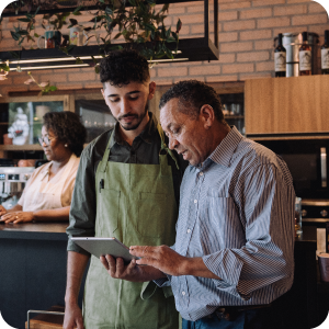 Two men looking at an ipad together.