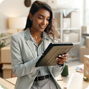 Business woman looking at her ipad and smiling.