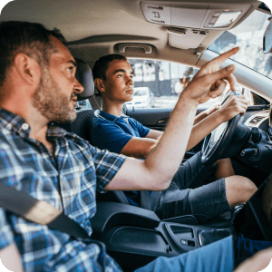 Father teaching son how to drive.