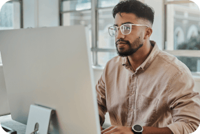 Man looking at his computer with interest.